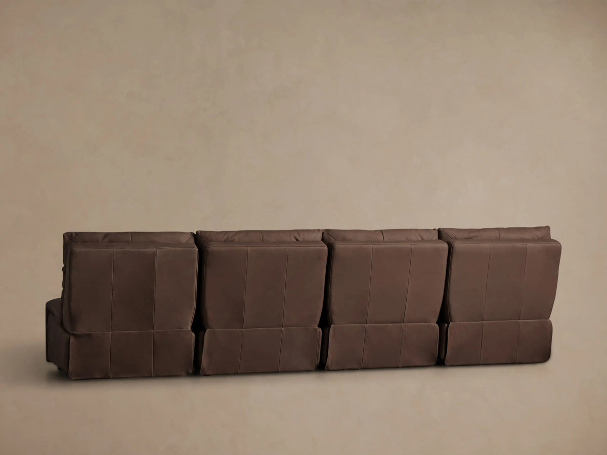 Close-up of rich, dark brown leather Rowland Armless Modular Sofa seat, backrest & two control buttons. Angled view.