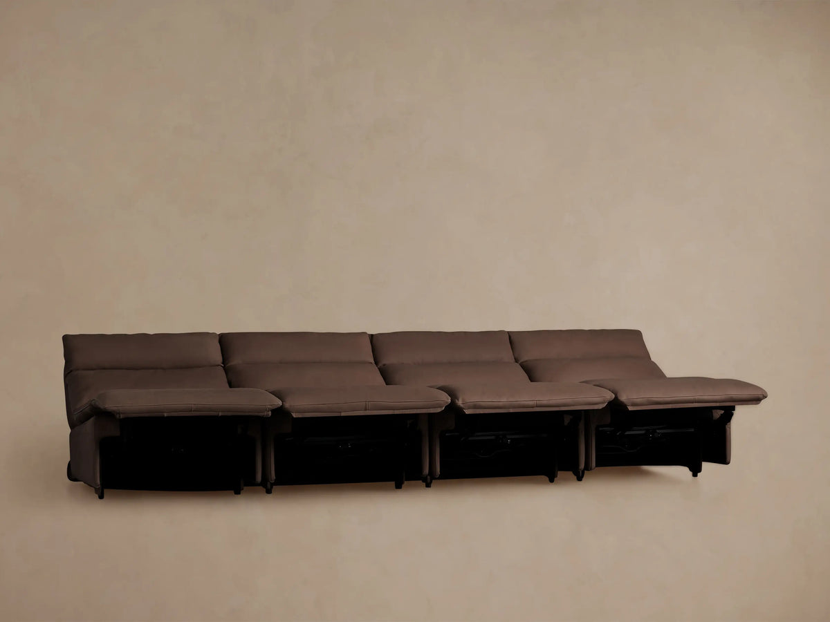 Rowland Tailored brown leather four-piece armless motion modular sofa, all sections partially reclined with footrests up.