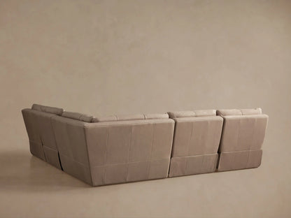 Light taupe Rowland Tailored Leather sectional, armless section reclined, footrest elevated, backrest angled back.