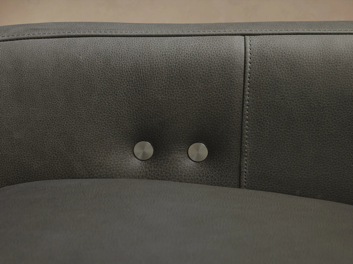 Dark gray Rowland Tailored Leather Six-Piece Motion Sectional, L-shaped, with clean, modern lines, on a hardwood floor.