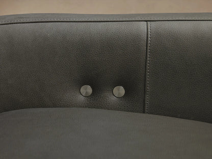 Dark gray Rowland Tailored Leather Six-Piece Motion Sectional, L-shaped, with clean, modern lines, on a hardwood floor.