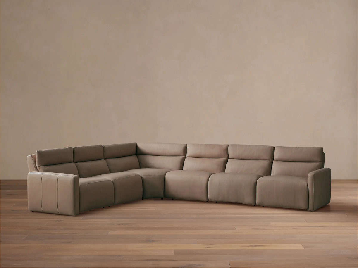 Rowland Tailored six-piece L-shaped motion sectional in light brown leather, positioned on a light wood floor.