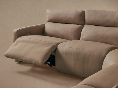Close-up of Rowland Tailored Leather Sectional's brown textured leather back with two metallic buttons & stitching.