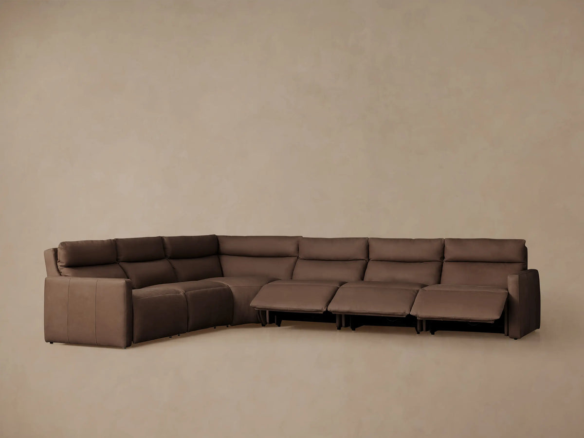 Taupe Rowland Tailored Leather Six-Piece Motion Sectional, L-shaped, with several seats partially reclined, on a light background.