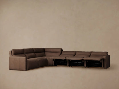 Rowland Tailored L-shaped leather motion sectional in dark brown, several footrests extended, against a plain wall.