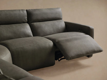 Detail of Rowland Tailored Leather Sectional, showing dark grey pebbled leather, two silver buttons, and vertical stitching.