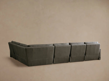 Dark grey Rowland Tailored Leather Motion Sectional with one recliner's footrest extended, showing its functionality.