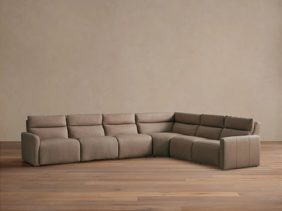 Rowland Tailored Leather Six-Piece Motion Sectional, light taupe, L-shaped, with plush cushions, on wooden floor.