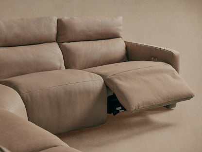 Close-up of Rowland Tailored Leather Motion Sectional's taupe leather backrest with vertical stitching and two bronze tufting buttons.