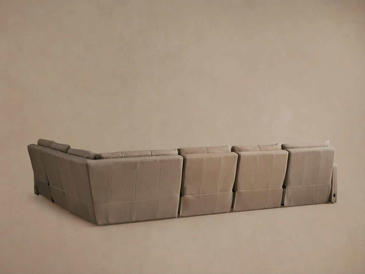 Rowland Tailored Leather Motion Sectional in light tan, close-up, with one power-reclined footrest extended.