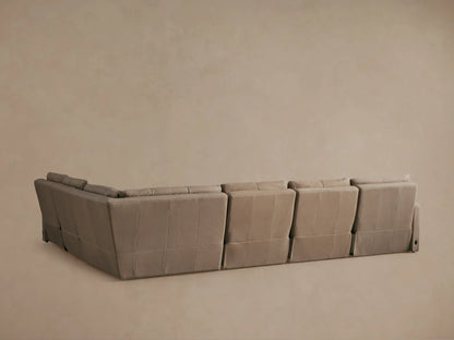 Rowland Tailored Leather Motion Sectional in light tan, close-up, with one power-reclined footrest extended.