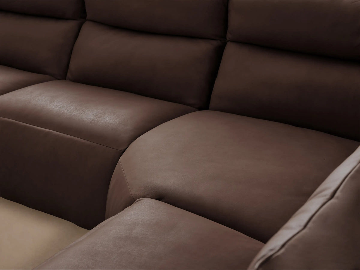 L-shaped Rowland Tailored Six-Piece Motion Sectional in dark brown leather, with individual reclining sections, on a wood floor.