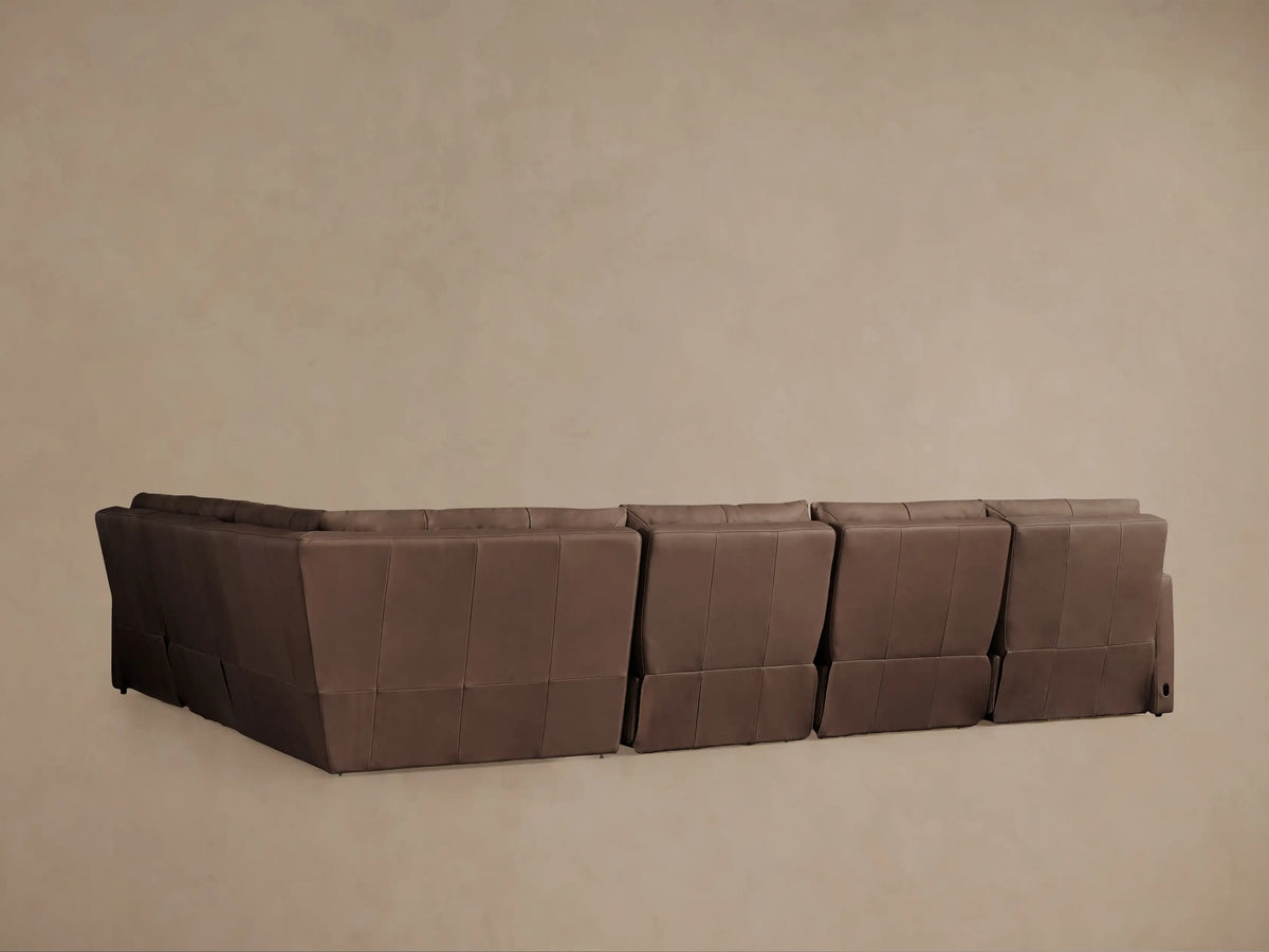 Close-up of Rowland Tailored Leather Sectional, rich brown leather on seat and soft, contoured back cushions, angled view.