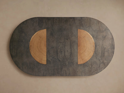 Oval Acacius Dining Table with a dark, naturally oxidized steel surface and a semi-circular reclaimed yukas veneer inlay.