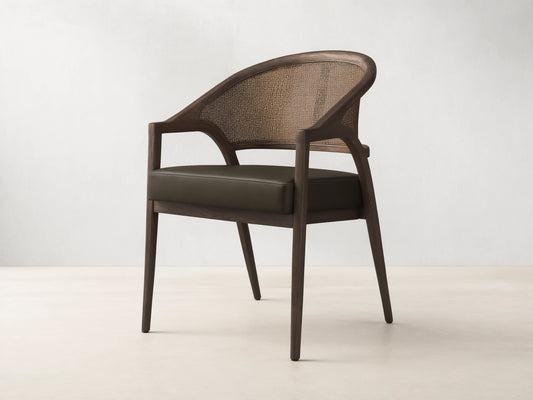 Front view of the Aimee Faux Leather Dining Arm Chair, featuring a dark oak frame, woven rattan back, and dark green faux leather seat.