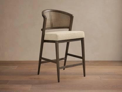 Aimee Armless Counter Stool with solid oak frame, rattan cane back, and upholstered seat. Hand-finished wood with lacquer.