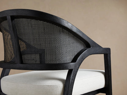 Aimee Dining Arm Chair with solid oak frame, rattan cane back, and white upholstered cushion seat, shown in Black Drifted finish.
