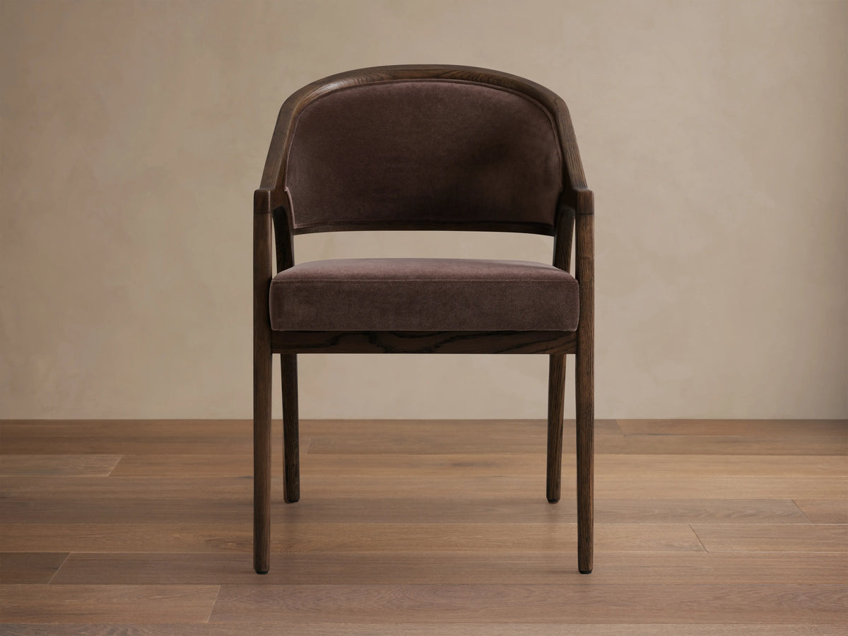 Side view of dark brown Aimee Upholstered Back Dining Arm Chair, with solid oak frame and upholstered back and seat.