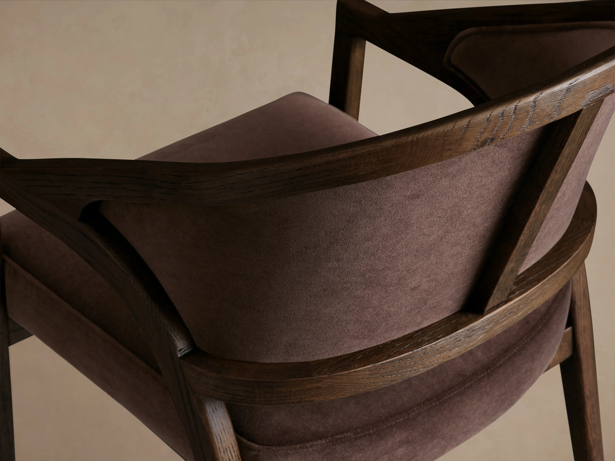 Aimee Upholstered Back Dining Arm Chair with a dark oak frame and brown cushioned seat and backrest, placed on wooden flooring.