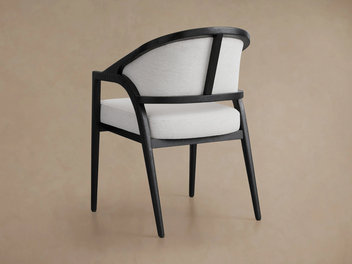 Aimee Upholstered Back Dining Arm Chair with solid oak frame, black wooden finish, and light fabric seat and backrest.