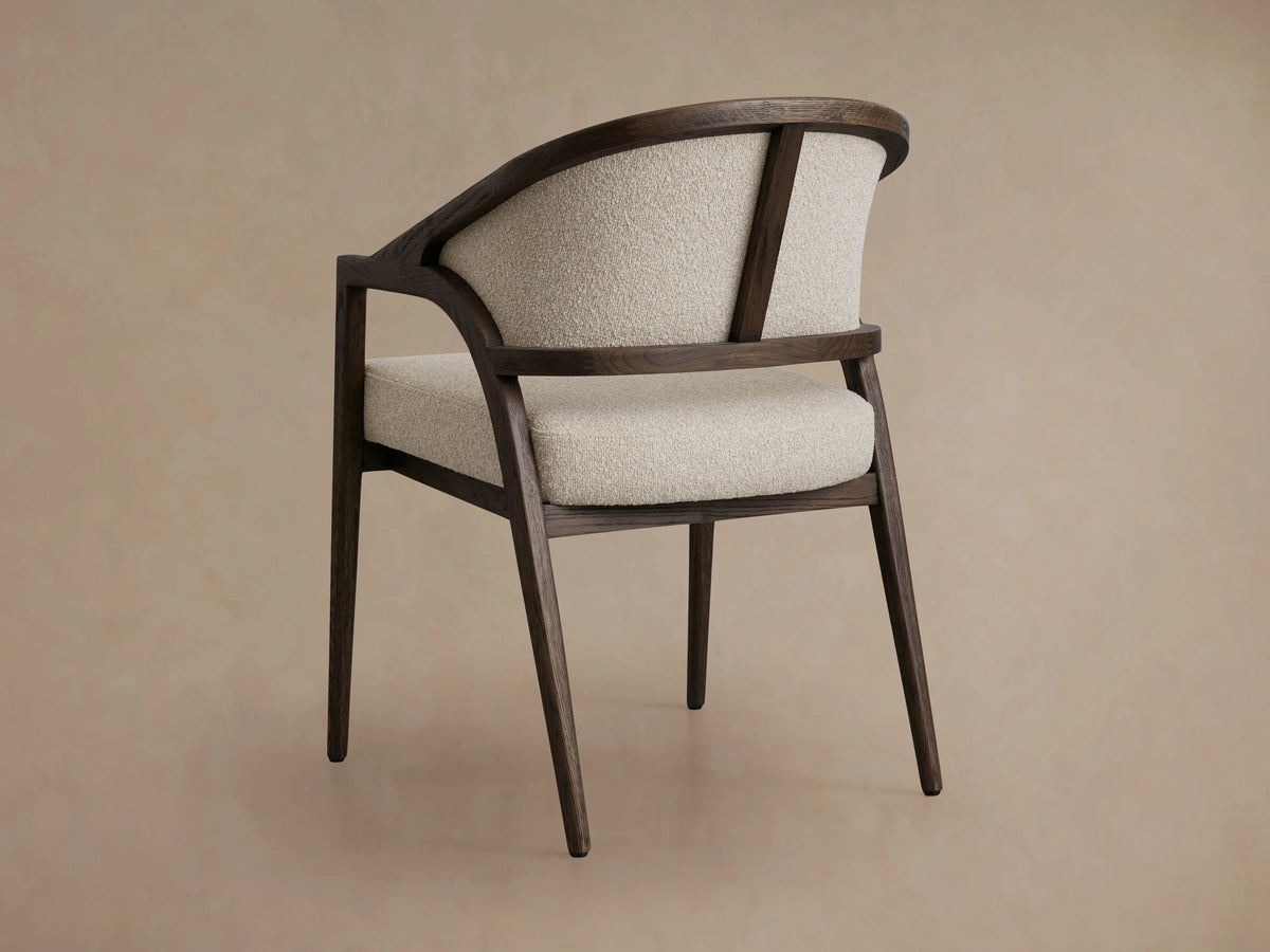 Aimee Upholstered Back Dining Arm Chair featuring textured light beige fabric with dark brown solid oak frame and curved arms.
