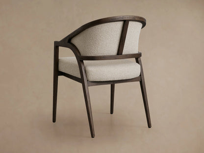 Aimee Upholstered Back Dining Arm Chair featuring textured light beige fabric with dark brown solid oak frame and curved arms.