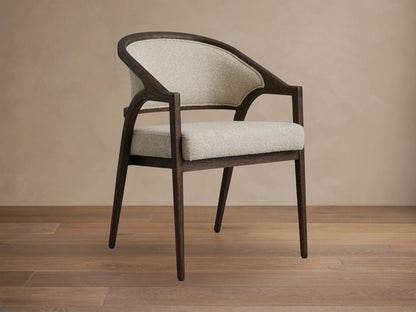 Aimee Upholstered Back Dining Arm Chair with curved dark oak frame, light beige fabric seat and back, shown from rear angle.
