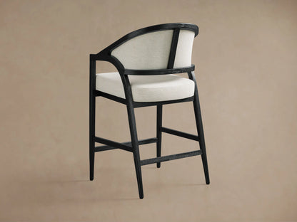 Aimee Upholstered Back Counter Stool with solid oak frame, black lacquer finish, and beige upholstered back and seat.