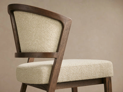 Aimee Upholstered Back Armless Counter Stool with solid oak frame, beige fabric seat and back, on wood floor, neutral backdrop.