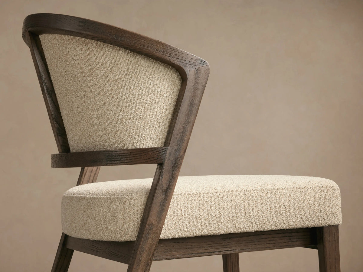 Aimee Upholstered Back Dining Side Chair with solid oak frame, beige upholstered back and seat, set on a wooden floor.