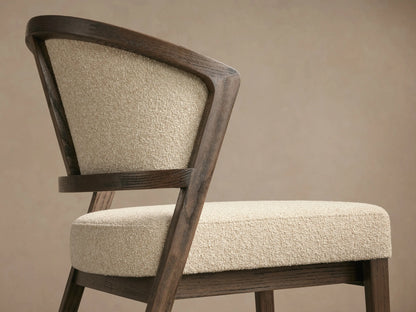 Aimee Upholstered Back Dining Side Chair with solid oak frame, beige upholstered back and seat, set on a wooden floor.
