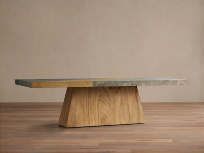 Almeria Dining Table with a guanacaste wood base and oxidized steel top, showing a distinct distressed patina on wooden floor.