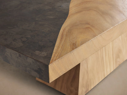 Almeria Dining Table with a rectangular top featuring guanacaste wood veneer and oxidized steel, on a tapered wooden base.