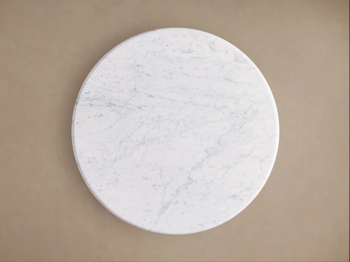 Amelia Bistro Table with white Carrara marble top & light oak wood-grain base, viewed from above at an angle.