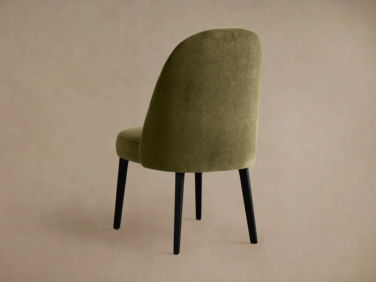 Arco Channel Dining Chair, close-up of olive green upholstered backrest with vertical channel detailing & curved seat.