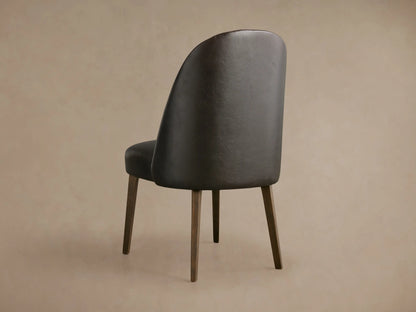 Arco Faux Leather Dining Chair: close-up of dark brown textured faux leather backrest with vertical channel detailing & seat.