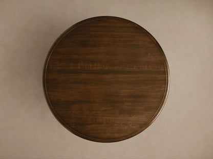 Round Asolo Dining Table with dark wood finish, hand-carved curvaceous pedestal, and subtle distressed detailing.