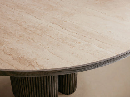 Astor Round Dining Table with light marble top and dark reeded oak cylindrical base on a wooden floor.