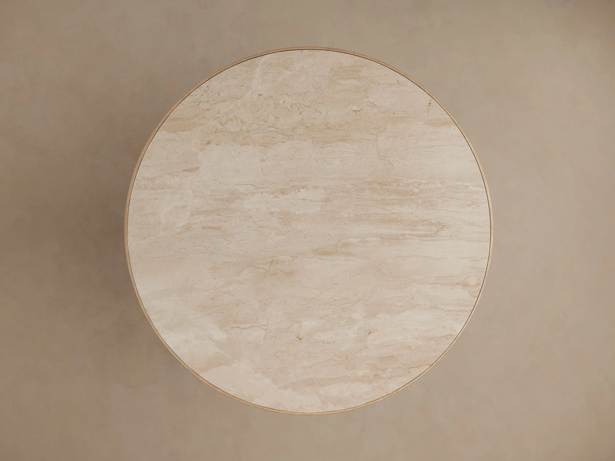 Astor Round Dining Table: close-up of light beige natural marble top with subtle veining and reeded oak wood base.