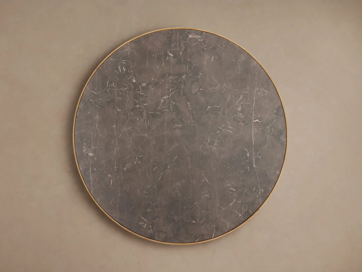 Astor Round Dining Table with dark marble top and vertical oak wood reeding detail, showcasing unique textures and colors.
