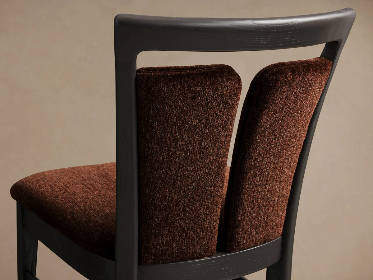 Front view of the Beatrice Dining Side Chair, featuring a dark ash wood frame with brown upholstered seat and split back.