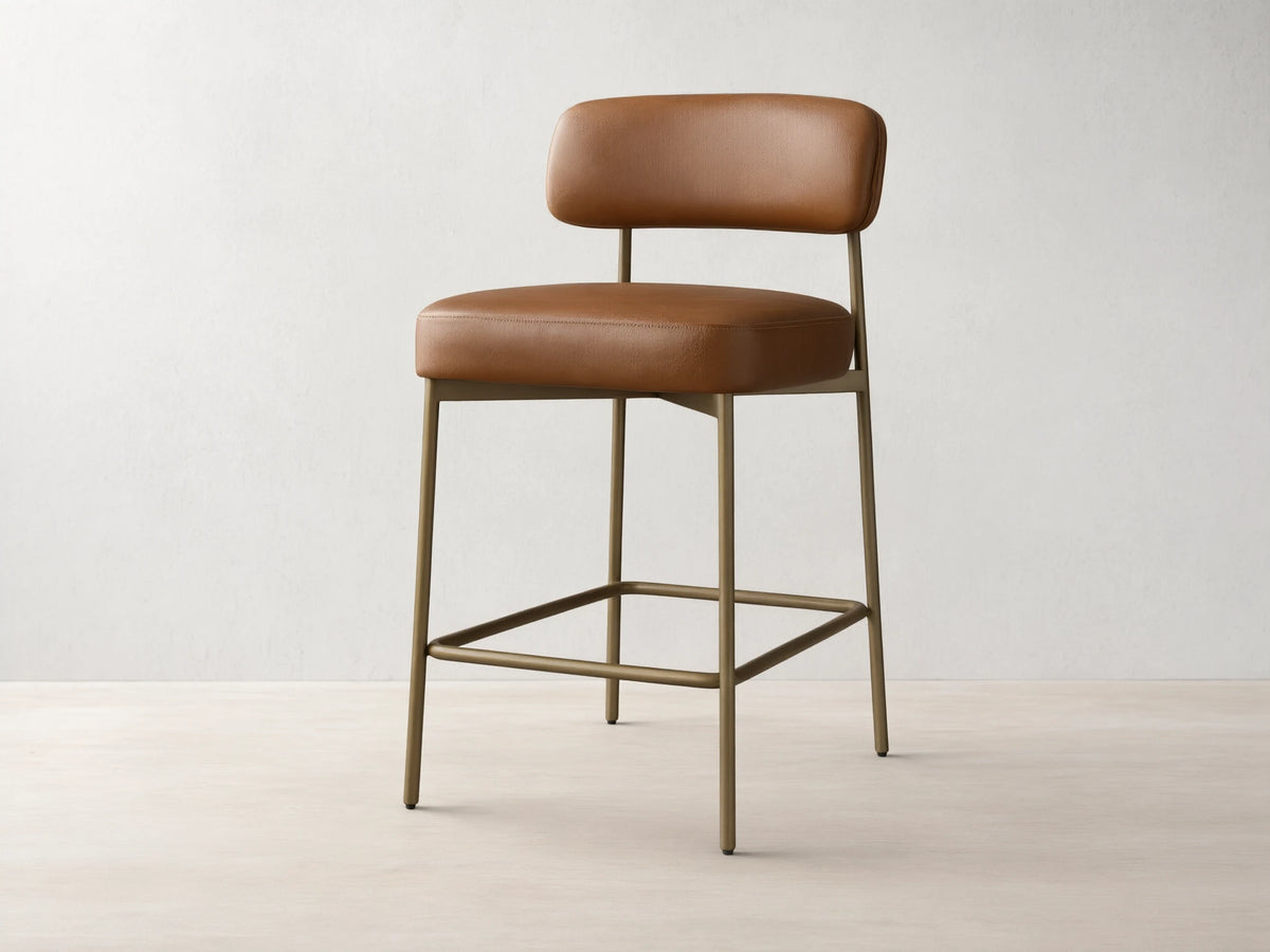 Front view of the brown Billie Stool in Faux Leather, featuring a padded seat and backrest, on an antiqued iron frame.