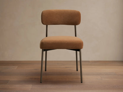 Billie Dining Chair in Antique Bronze, with a padded golden yellow seat and backrest on an antiqued iron frame.