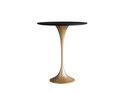 Saint Germain Counter Table with a round black marquina marble tabletop featuring white veining, viewed from above on a beige background.