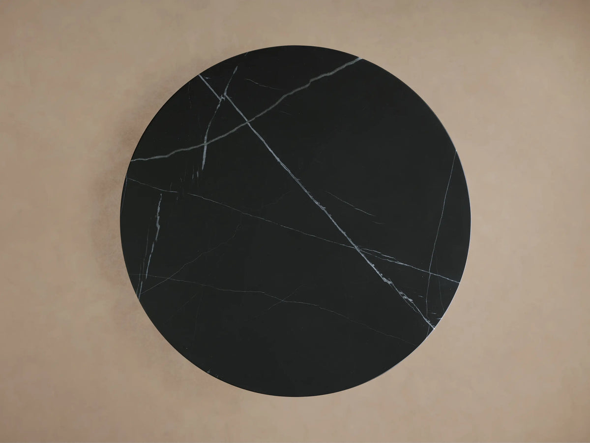 Saint Germain Bistro Table with black marquina marble top featuring white veining, and a gold-toned steel base.