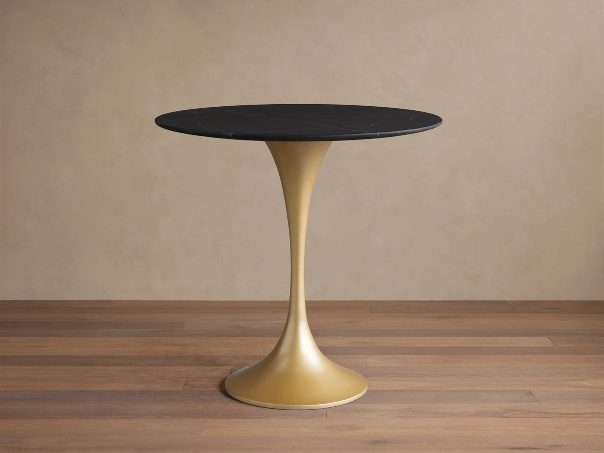 Round black marquina marble tabletop of the Saint Germain Bistro Table, featuring white veining, viewed from above.