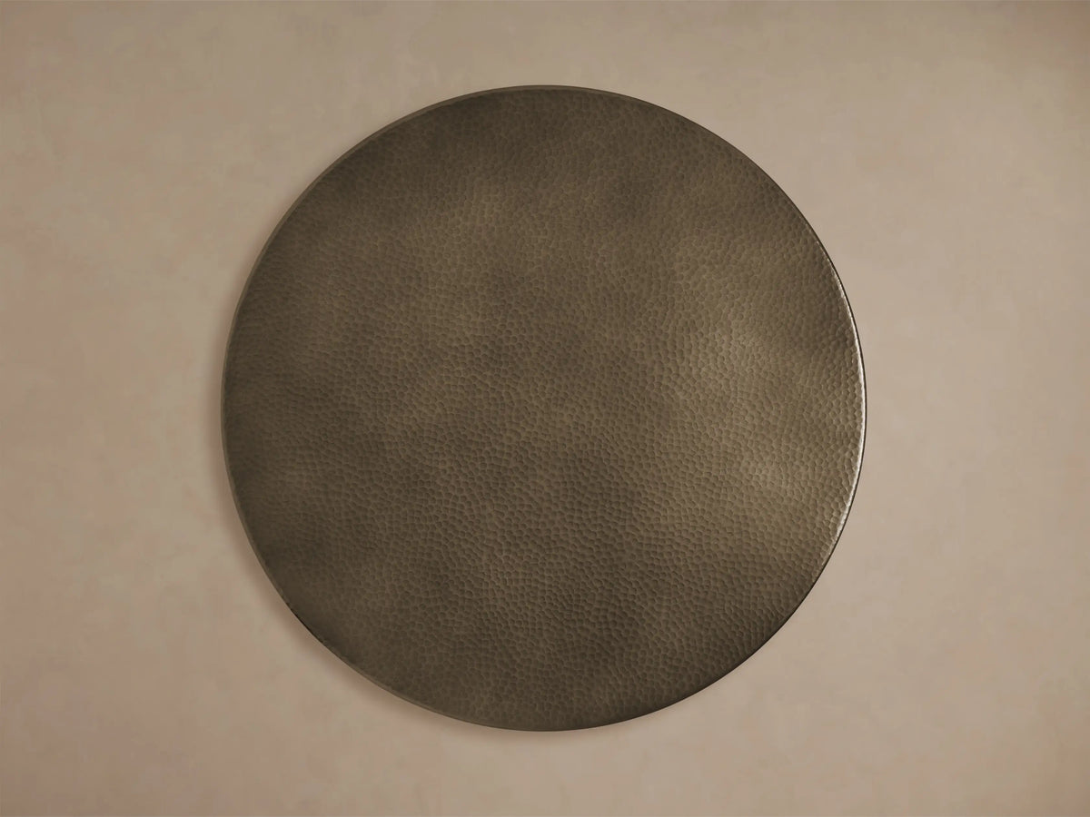 Close-up of the dark bronze-toned, hammered Recycled Metal Bistro Table with Wade Base, featuring a butterfly detail.