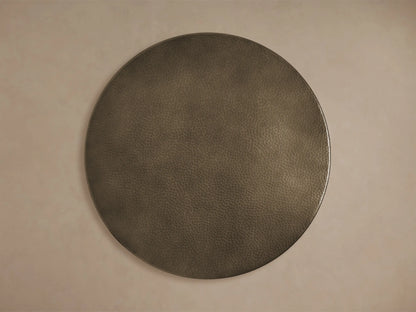 Close-up of the dark bronze-toned, hammered Recycled Metal Bistro Table with Wade Base, featuring a butterfly detail.