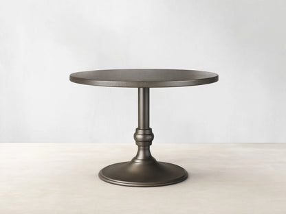 Front view of a brass-finished Recycled Metal Bistro Table with Wade Base, featuring a round top and flared pedestal base.