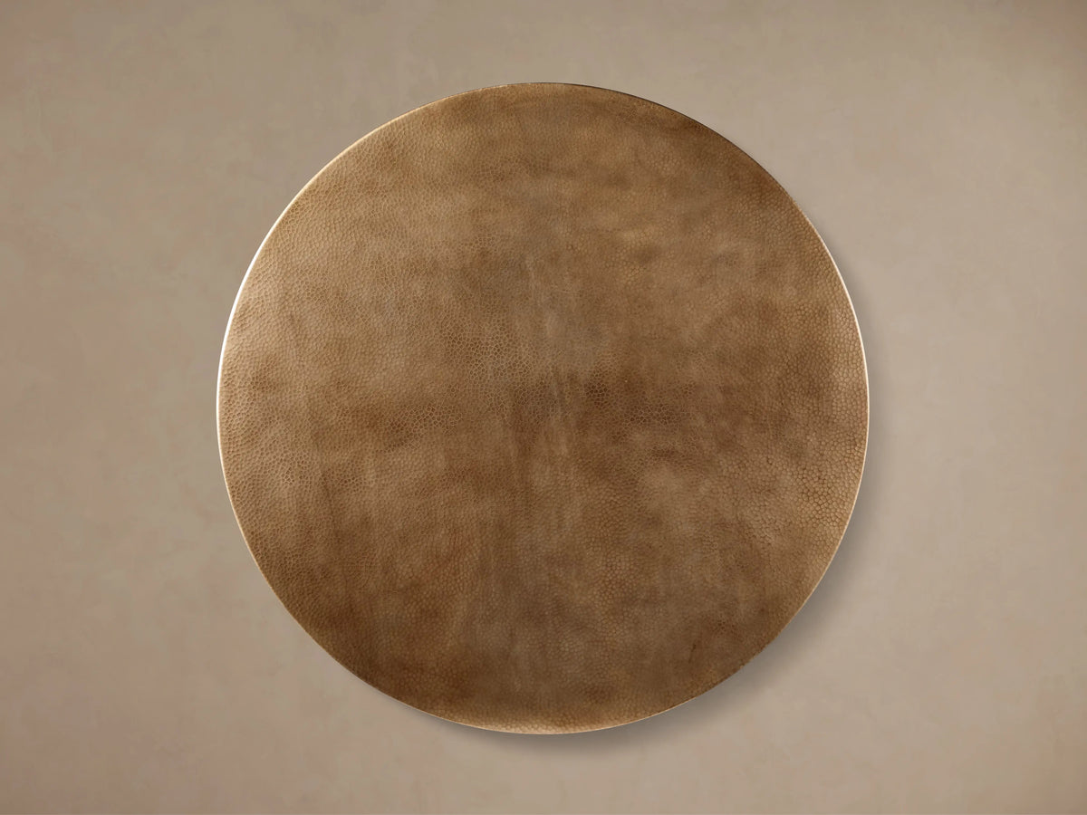 Recycled metal bistro table with round, distressed brass-finished top and dark bronze Wade pedestal base.